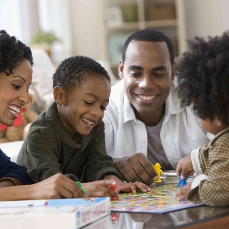 african-american-family-playing-board-game-together-135538056-e4b4006222b1449ba823dd79d4224138